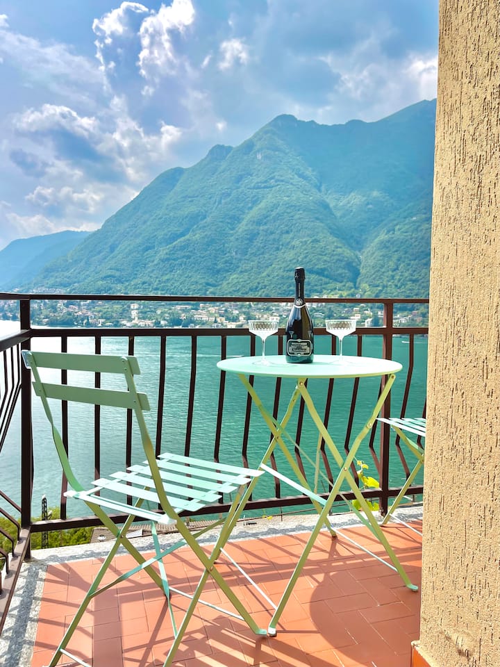 Balcony bistro table with prosecco against the Lake Como panorama
