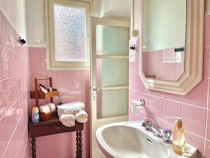 Pink bathroom sink and towels