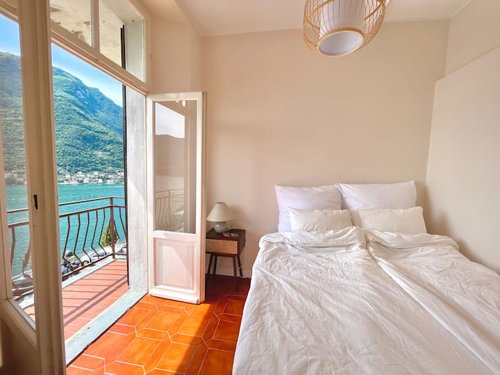 Bedroom with balcony door open to the lake