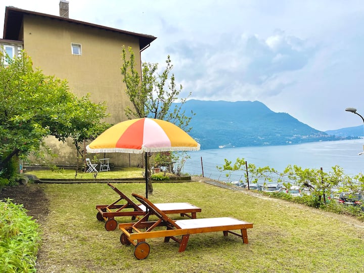 Sun loungers and fringed umbrella in the garden