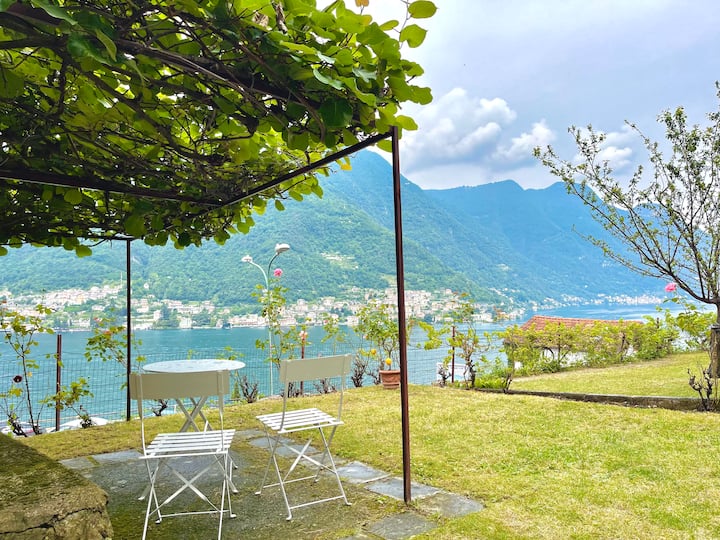 Bistro chairs under the pergola overlooking the lake