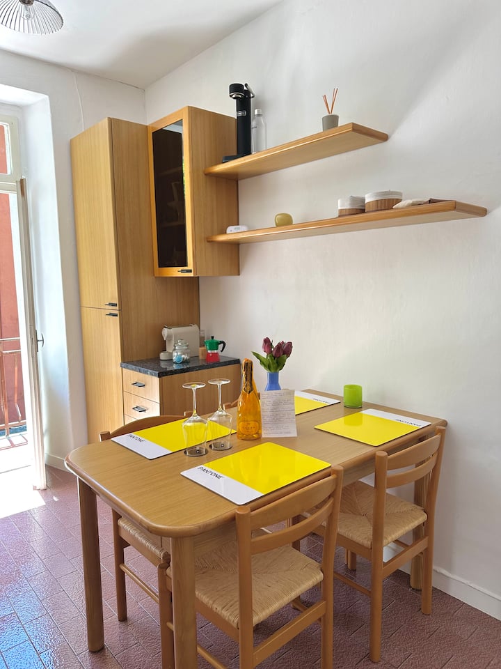 Dining table with yellow placemats in the kitchen