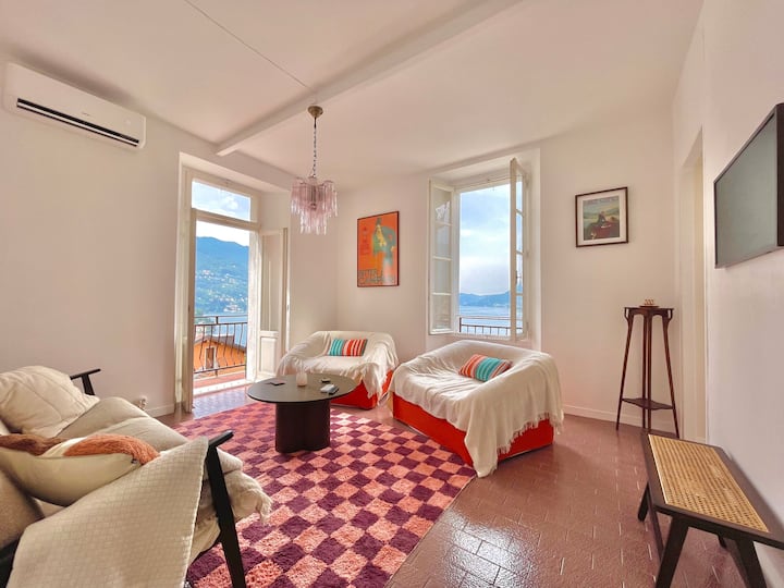 Living room with checkered rug and orange sofas